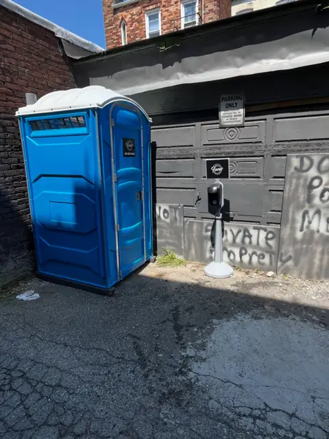 Porta potty in a home driveway