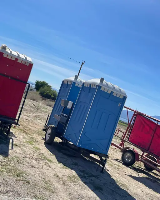 Towable porta potty in a farm field